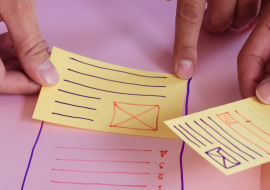 group of hands placing sticky notes